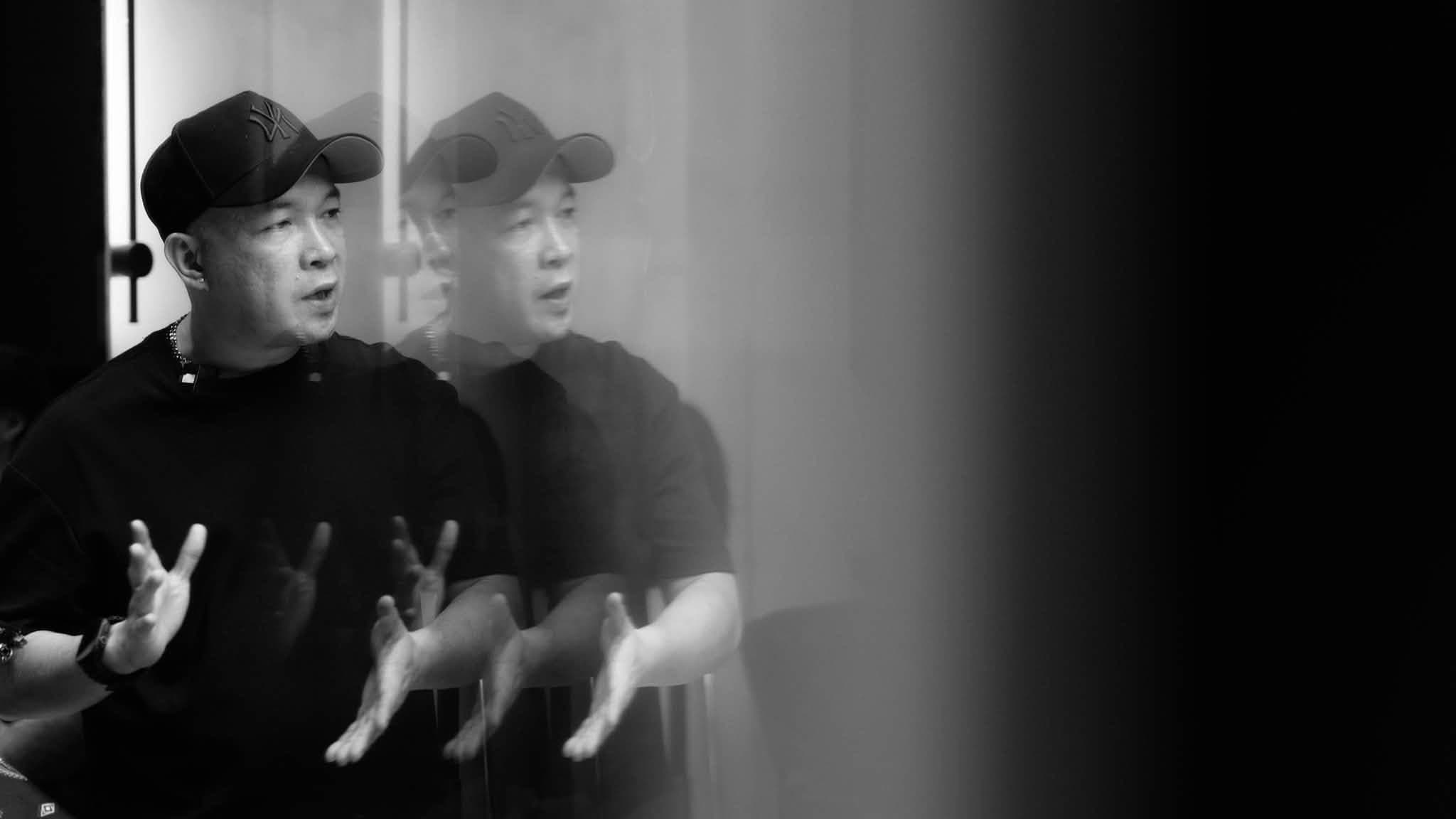 A PARE barber explaining his approach, reflected in the mirror