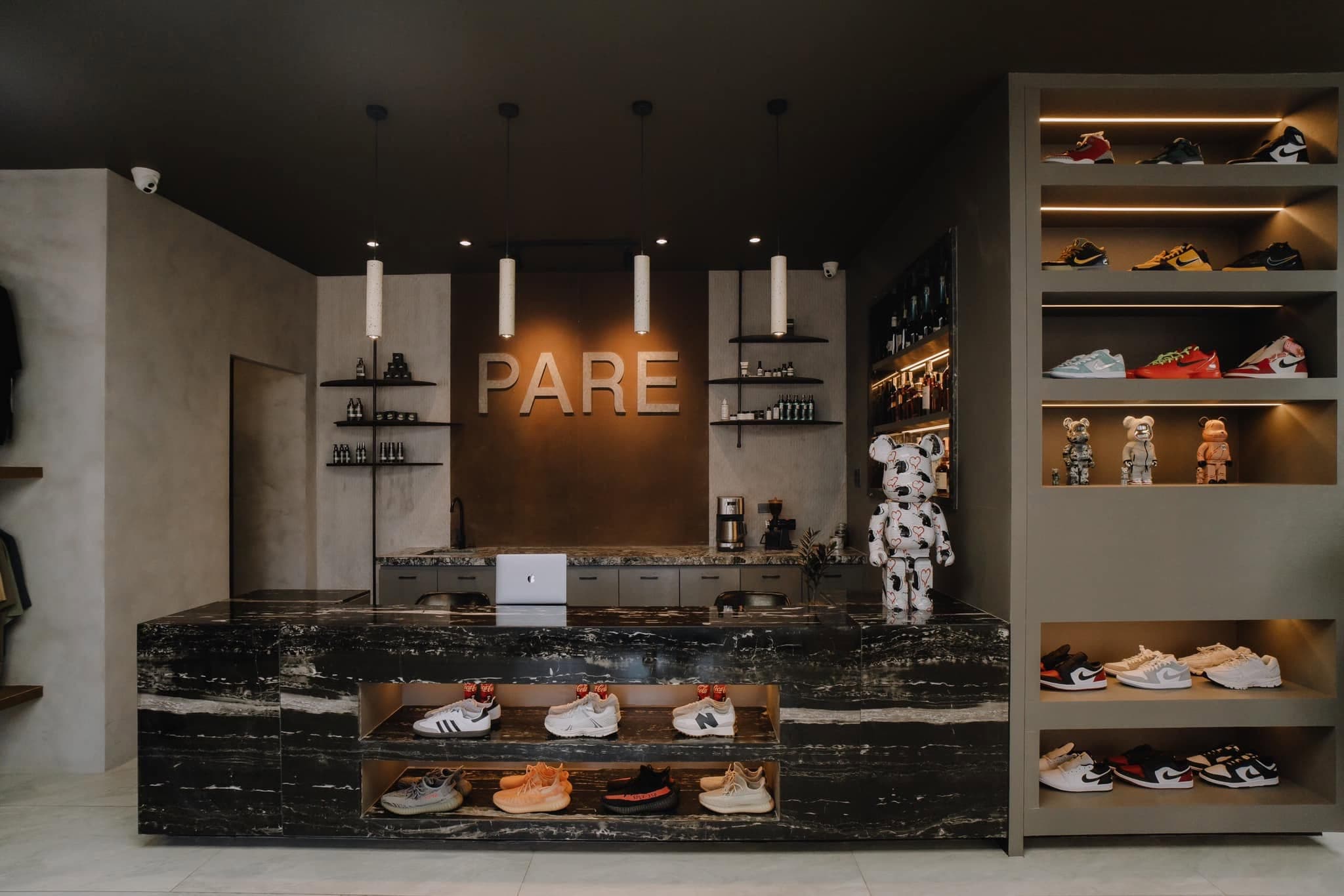 Inside PARE: the marble front counter, sneaker shelves and the PARE wall sign